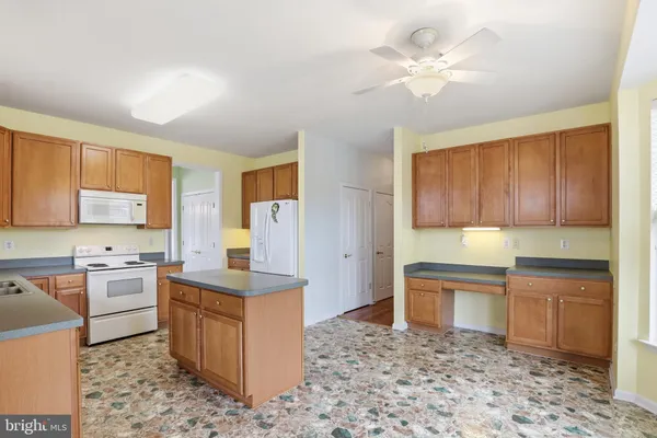 a kitchen with a stove a sink and a refrigerator