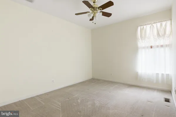 a view of an empty room with a balcony