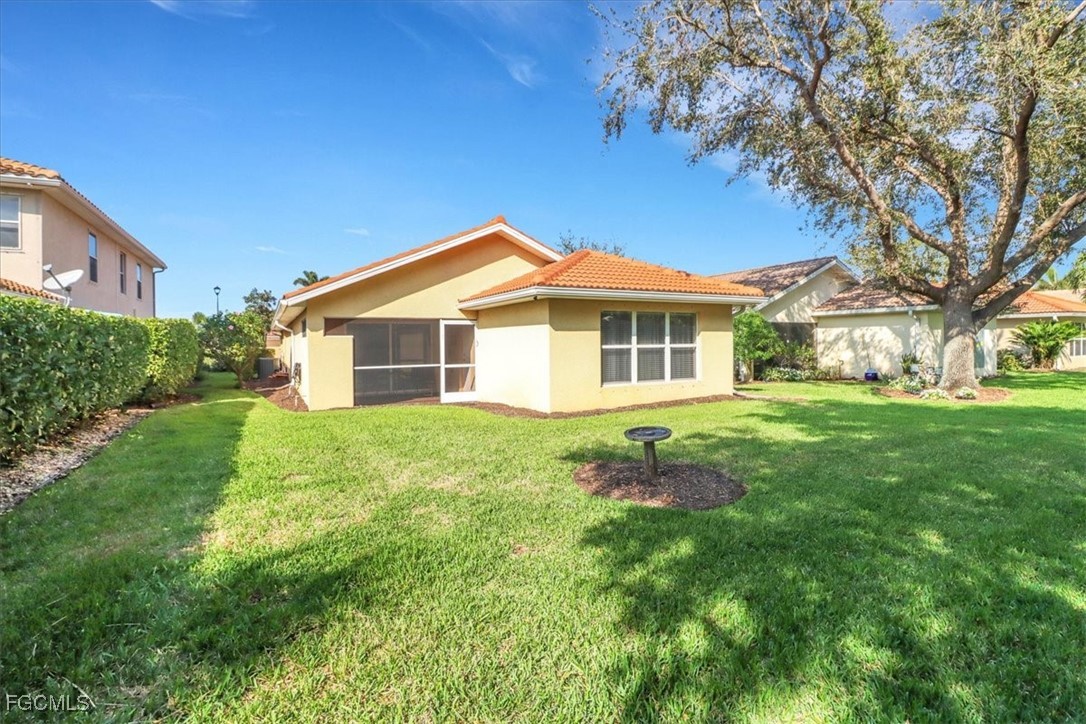 19674 Villa Rosa Loop Estero, FL 33967 - Photo 18 of 33 a view of a house with a yard