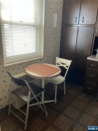 a view of a dining room with furniture and a window