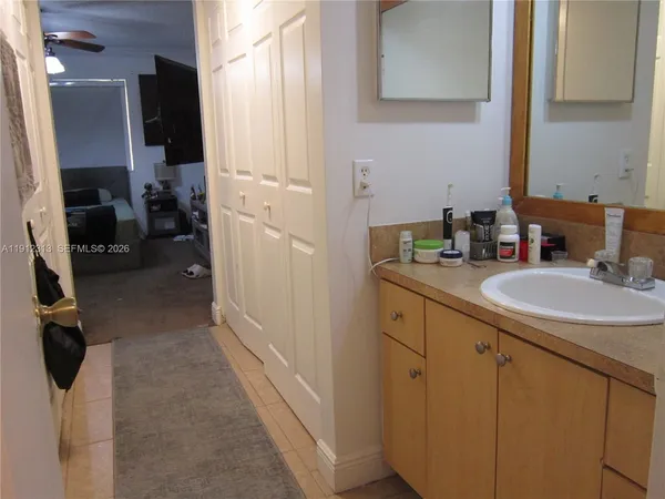 a bathroom with sink a mirror and vanity