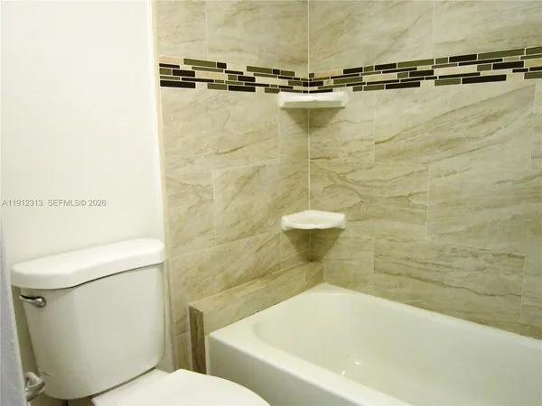 a bathroom with a toilet and a bathtub