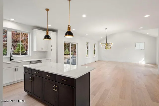 a kitchen with a sink chandelier and window