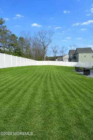 a view of a field of grass and trees