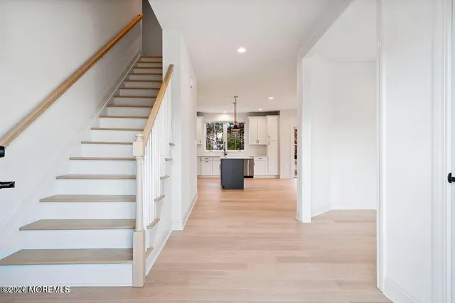 a view of a kitchen with wooden floor and stairs