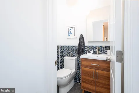 a bathroom with a toilet a sink and mirror
