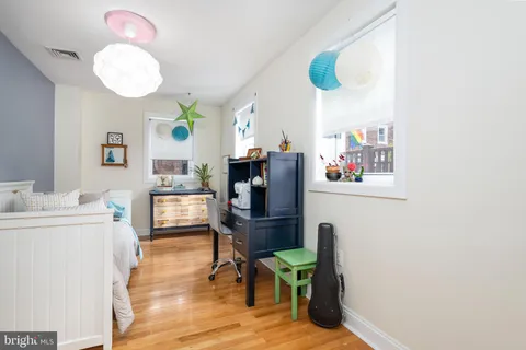 a view of a dining room with furniture and a chandelier