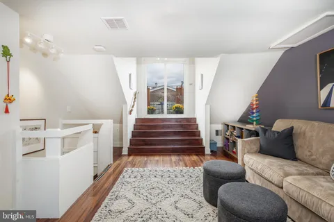 a living room with furniture and a book shelf