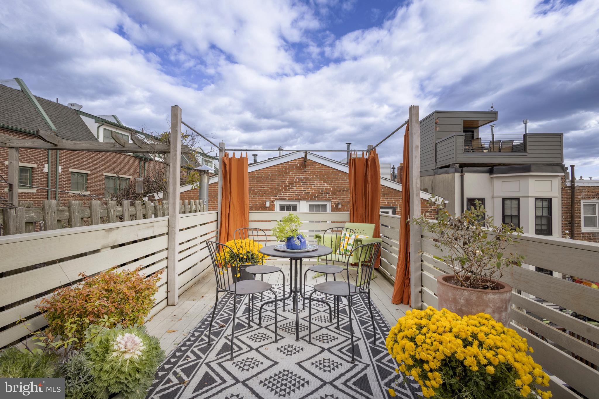 929 South 6th Street Philadelphia, PA 19147 - Photo 26 of 28 a balcony with table and chairs and potted plants