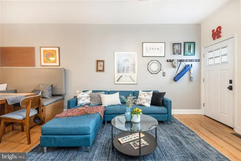 a living room with furniture and wooden floor