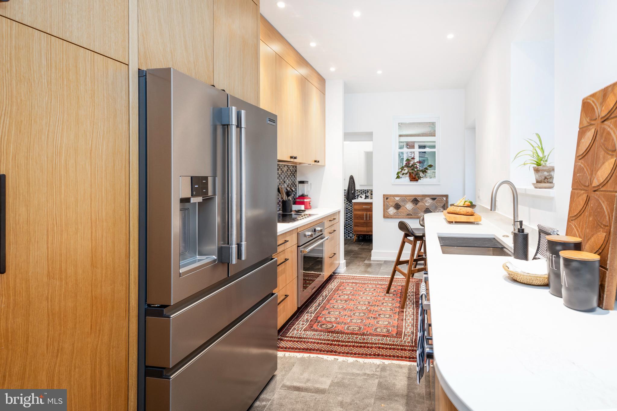 929 South 6th Street Philadelphia, PA 19147 - Photo 6 of 28 a kitchen with stainless steel appliances a refrigerator and a stove