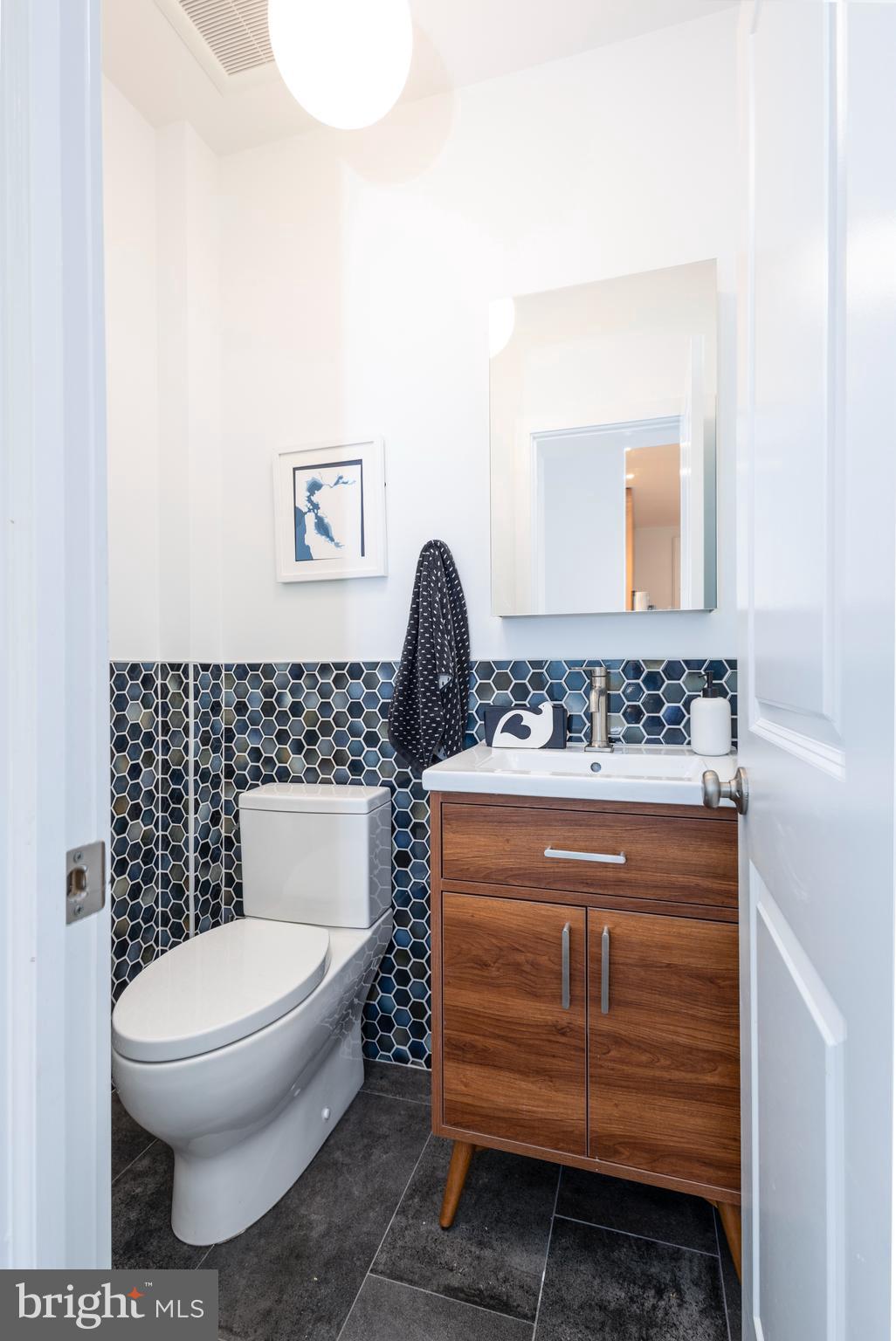 929 South 6th Street Philadelphia, PA 19147 - Photo 10 of 28 a bathroom with a toilet a sink and mirror