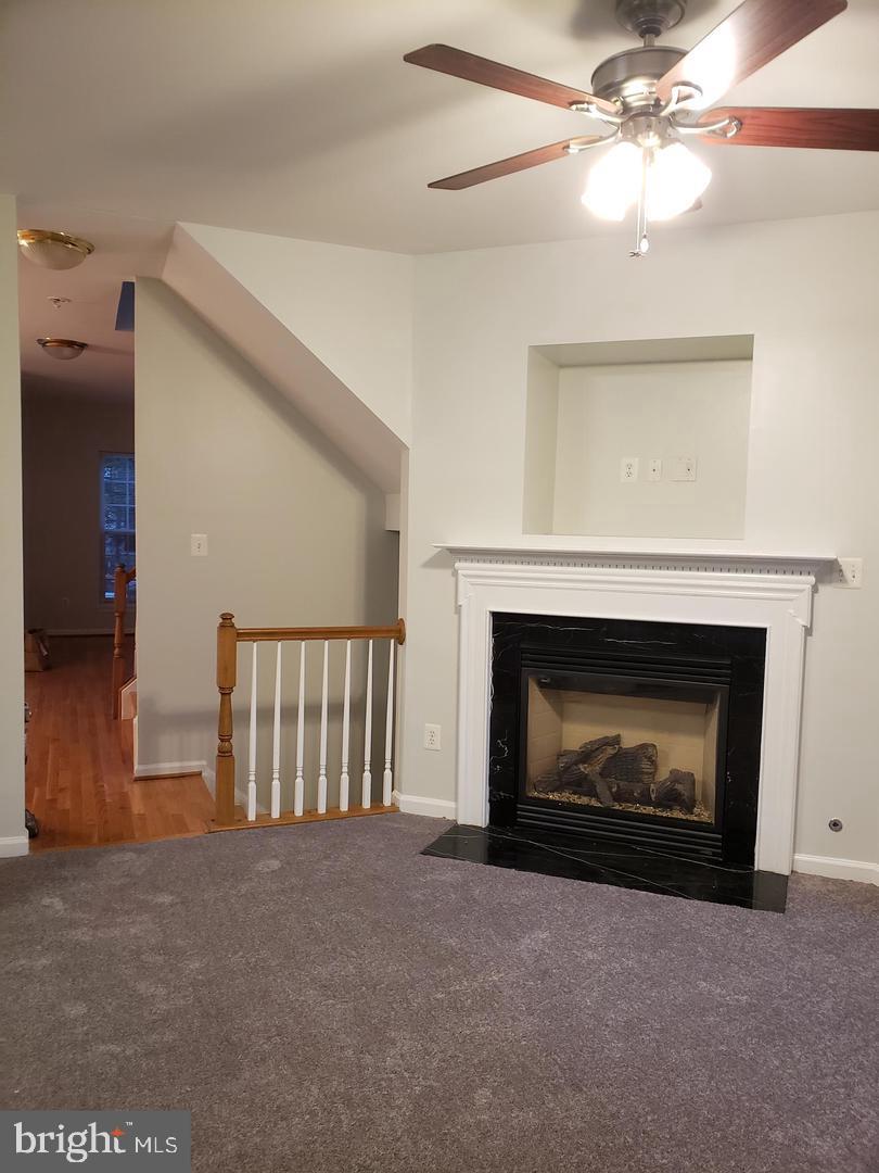 43967 Peony Place California, MD 20619 - Photo 12 of 27 a living room with furniture and a fireplace