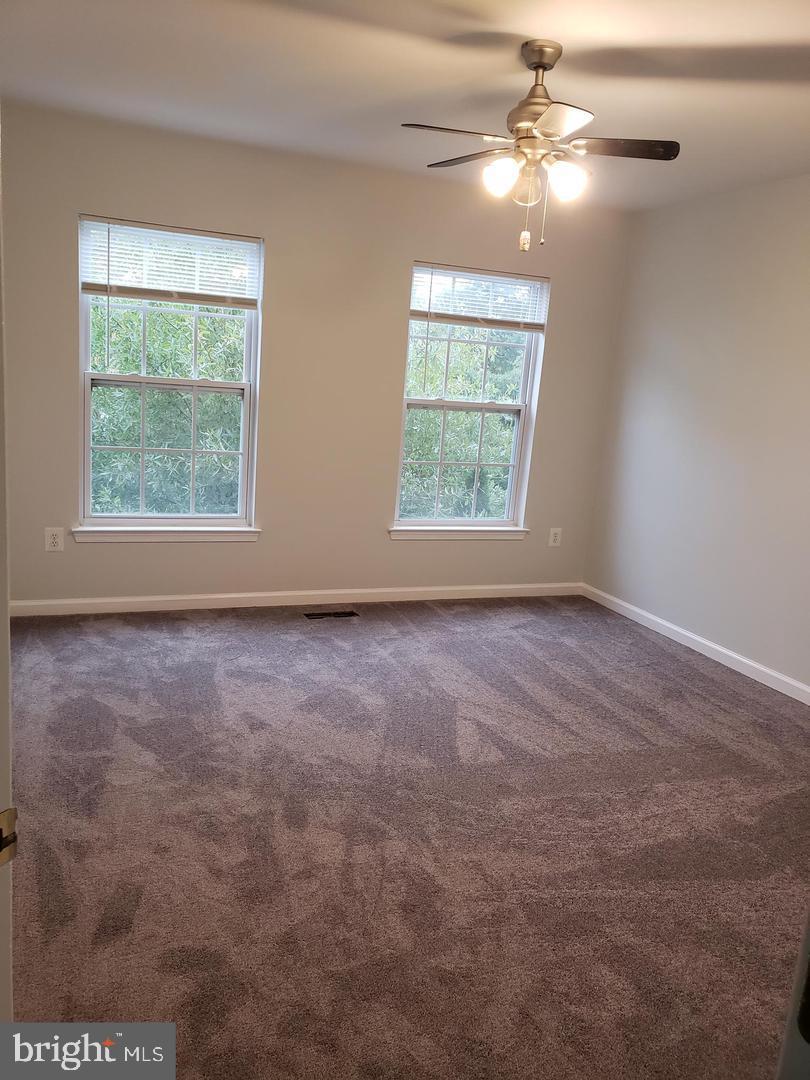 43967 Peony Place California, MD 20619 - Photo 15 of 27 an empty room with windows and fan