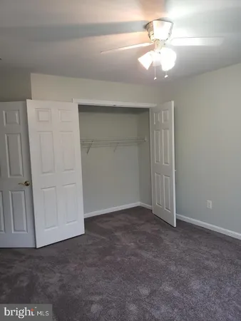 a view of an empty room with a ceiling fan