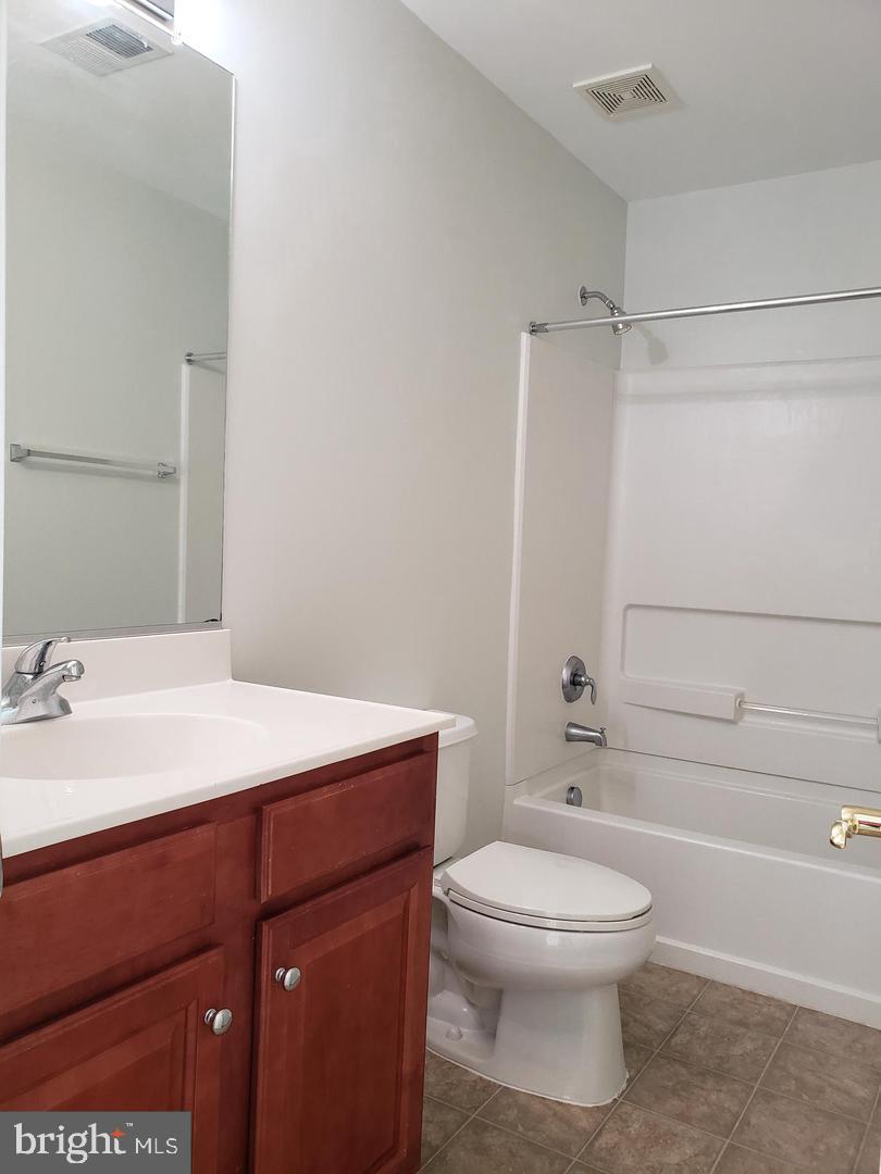 43967 Peony Place California, MD 20619 - Photo 19 of 27 a bathroom with a sink a toilet and shower