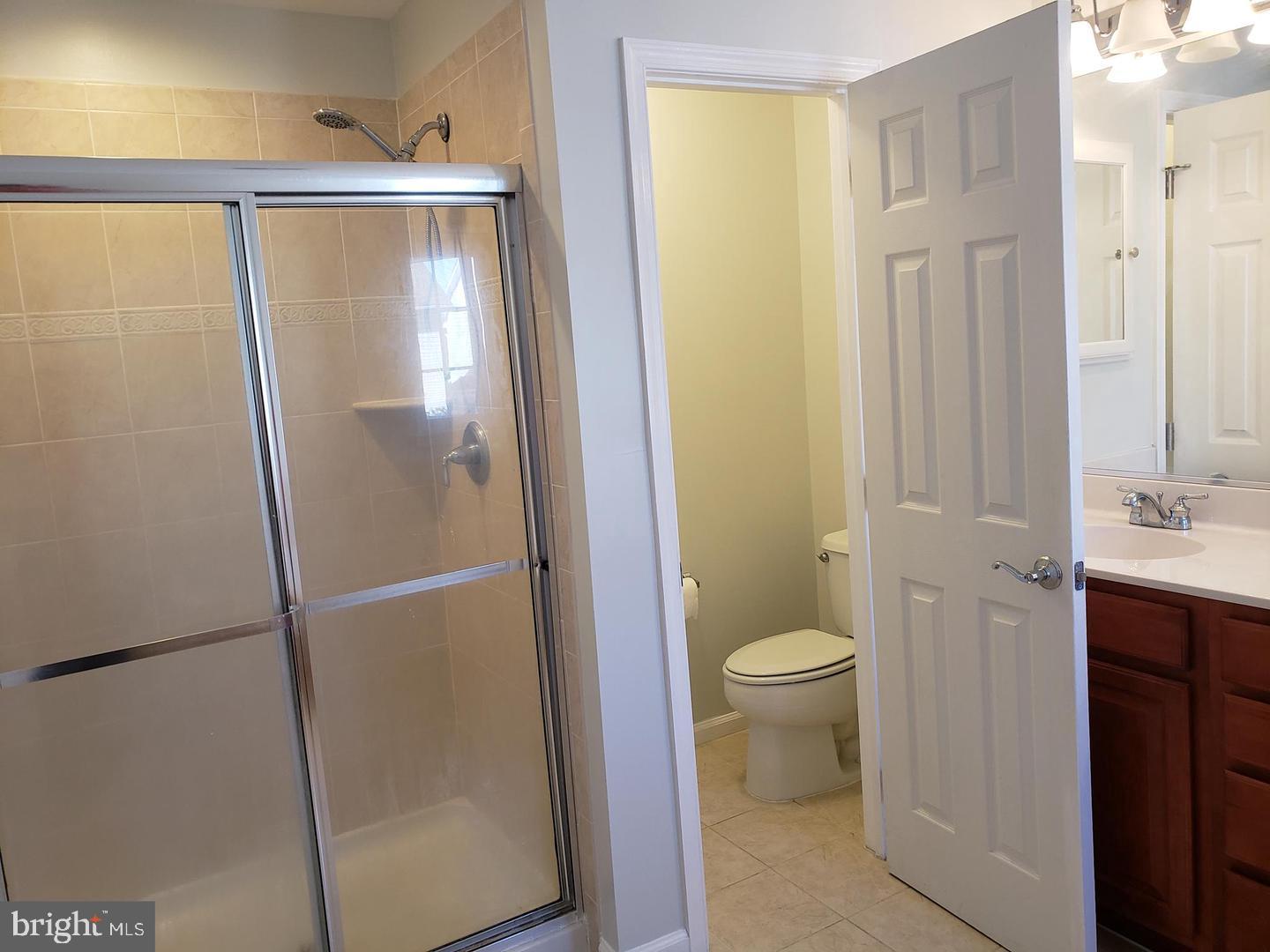 43967 Peony Place California, MD 20619 - Photo 20 of 27 a bathroom with a granite countertop sink toilet and shower