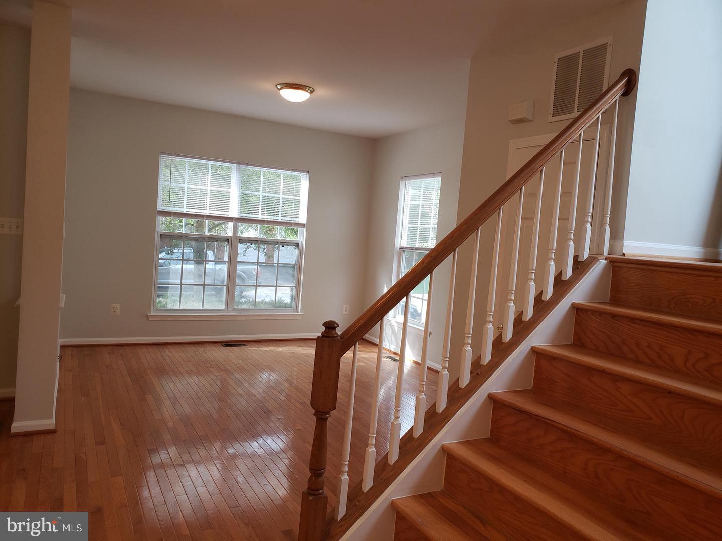 43967 Peony Place California, MD 20619 - Photo 5 of 27 a view of staircase with wooden floor and fan