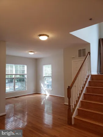 a view of an entryway with wooden floor