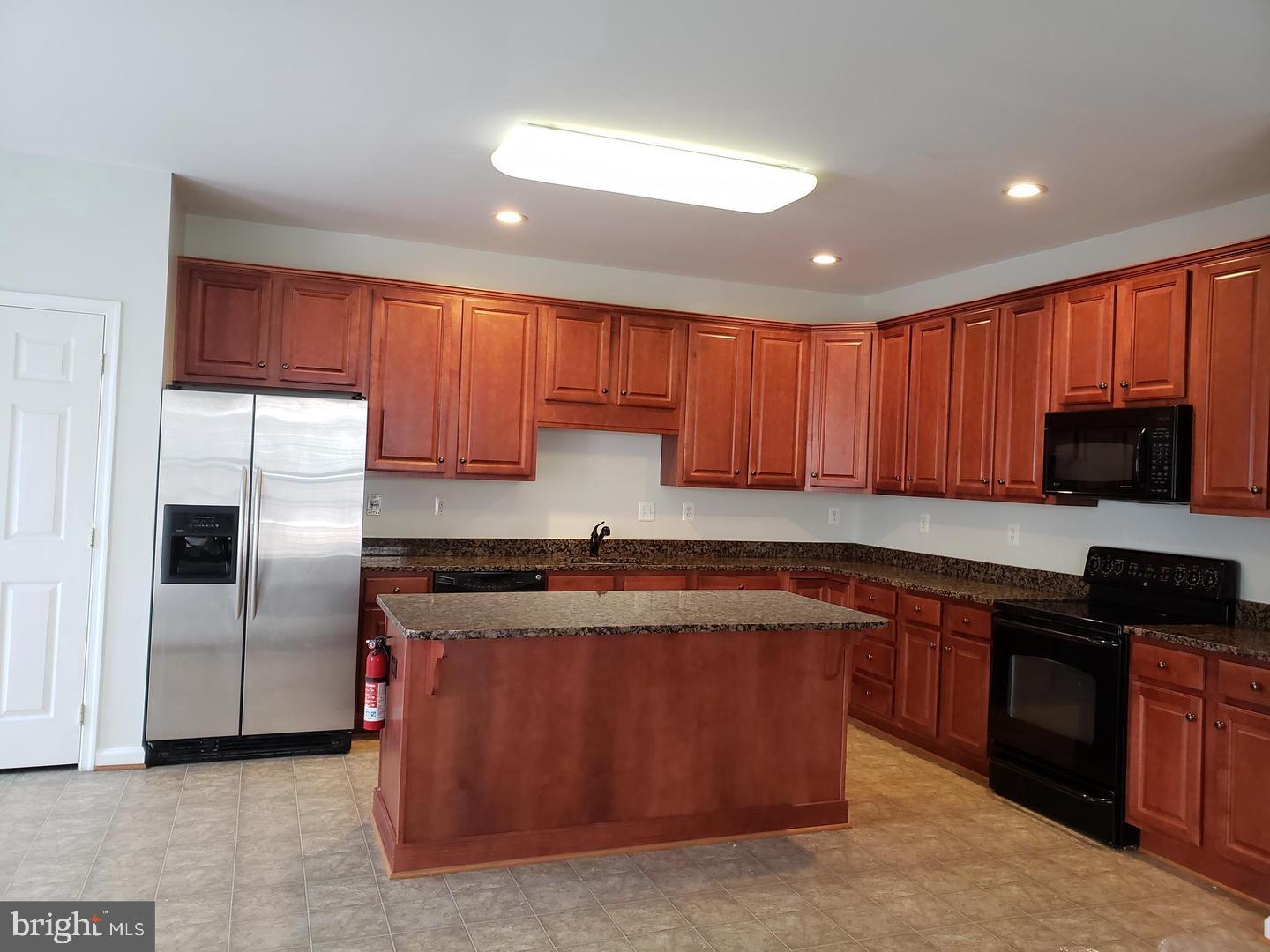 43967 Peony Place California, MD 20619 - Photo 7 of 27 a kitchen with stainless steel appliances granite countertop a stove a sink dishwasher a refrigerator and cabinets with wooden floor