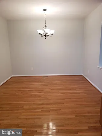 a view of a room with an empty space and a ceiling fan