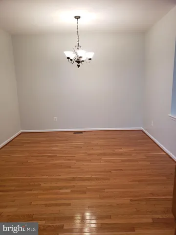 a view of a room with an empty space and a ceiling fan