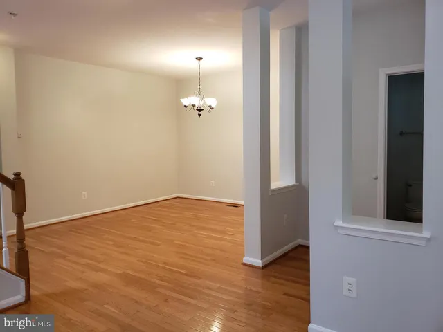 an empty room with wooden floor