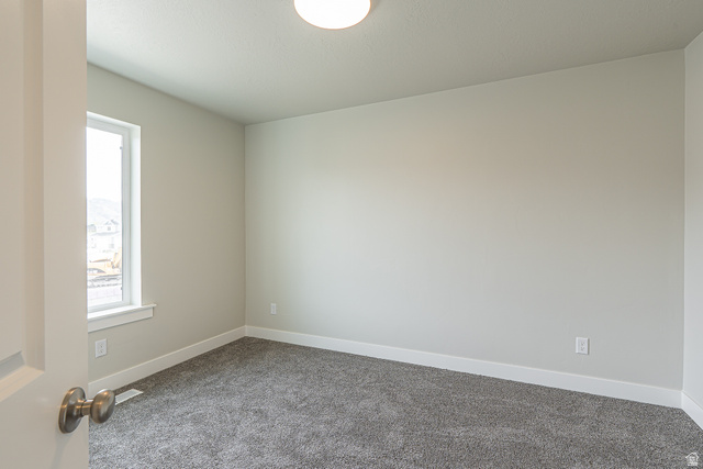 2249 South 1090 West, Unit 76 Nibley, UT 84321 - Photo 9 of 19 Spacious room featuring neutral paint, gray carpet flooring, a single window, and a flush mount ceiling light