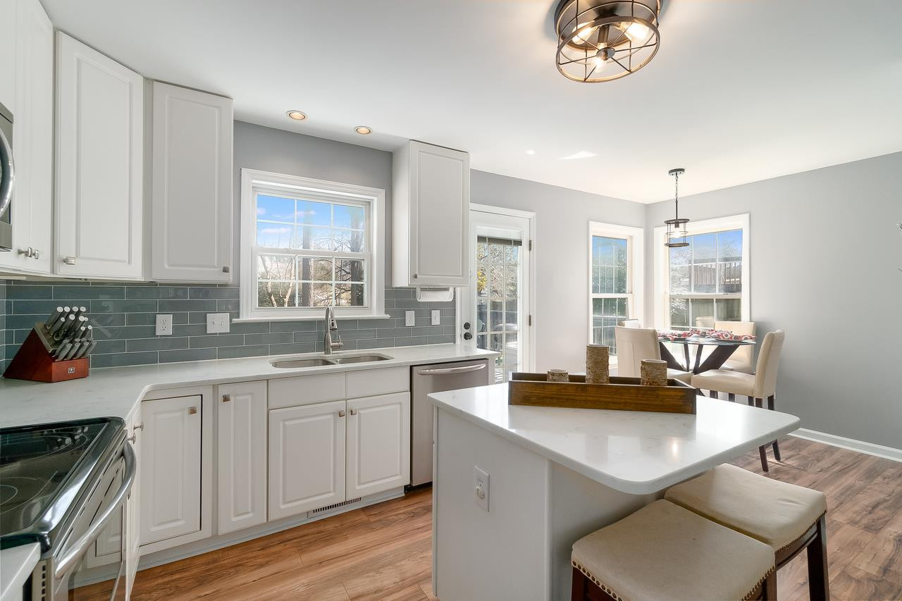 8727 Harps Mill Road Raleigh, NC 27615 - Photo 8 of 25 Stainless Steel Appliances & New Fixtures! The ISLAND is not only beautiful, but FUNCTIONAL for extra seating too! Kitchen