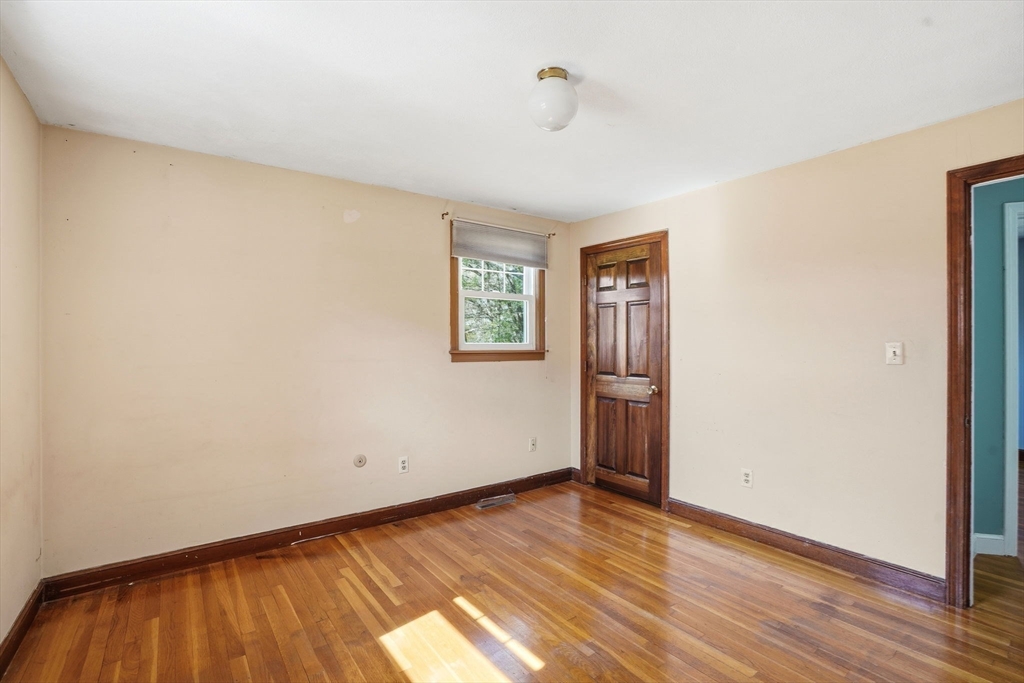 3 Fairway Drive Canton, MA 02021 - Photo 17 of 34 a view of an empty room with wooden floor and a window