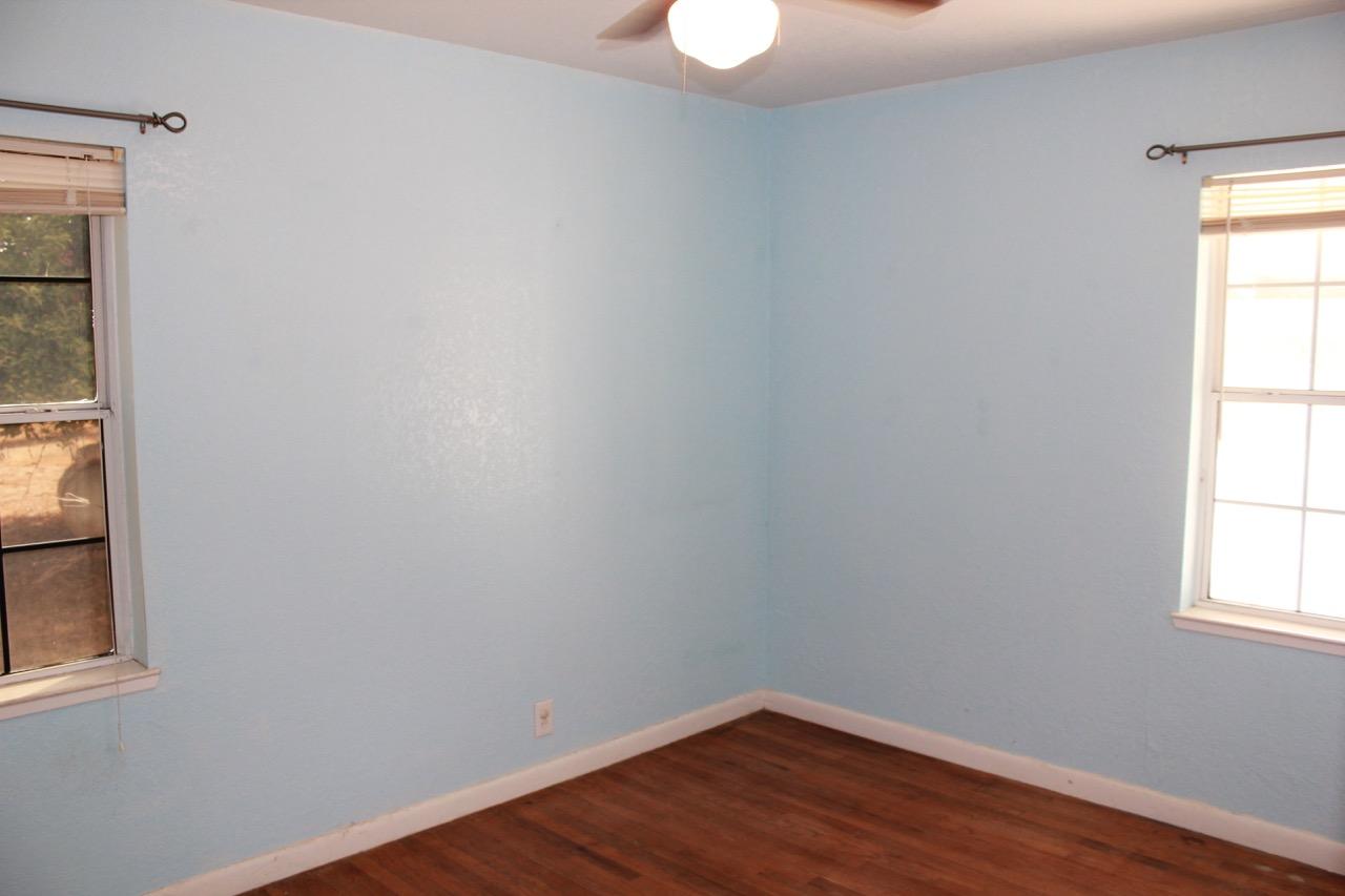 19819 Reeds Creek Road Red Bluff, CA 96080 - Photo 11 of 18 a view of an empty room with wooden floor and a window