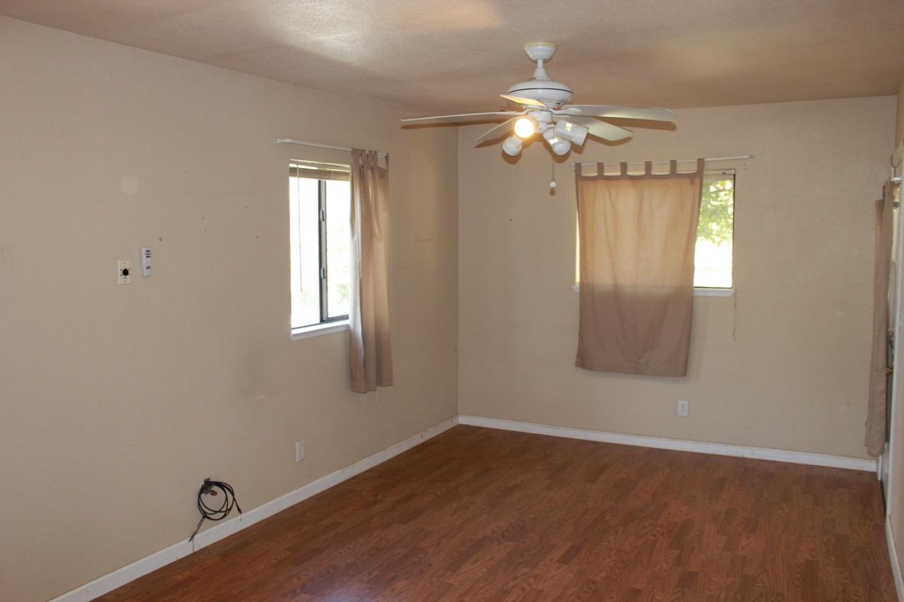 19819 Reeds Creek Road Red Bluff, CA 96080 - Photo 15 of 18 a view of a livingroom with a chandelier fan and wooden floor