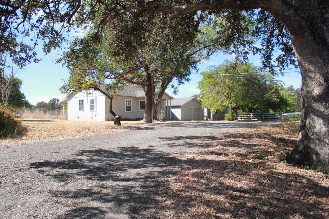 19819 Reeds Creek Road Red Bluff, CA 96080 - Photo 4 of 18 a view of white house with a snow on the road