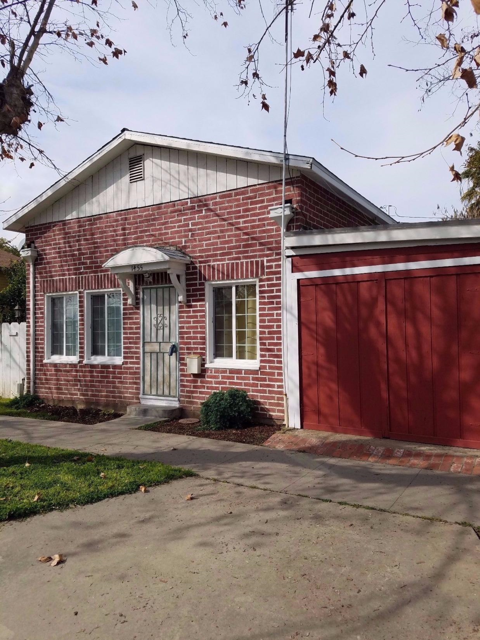 1455 10th Street Reedley, CA 93654 - Photo 1 of 9 a front view of a house with a yard