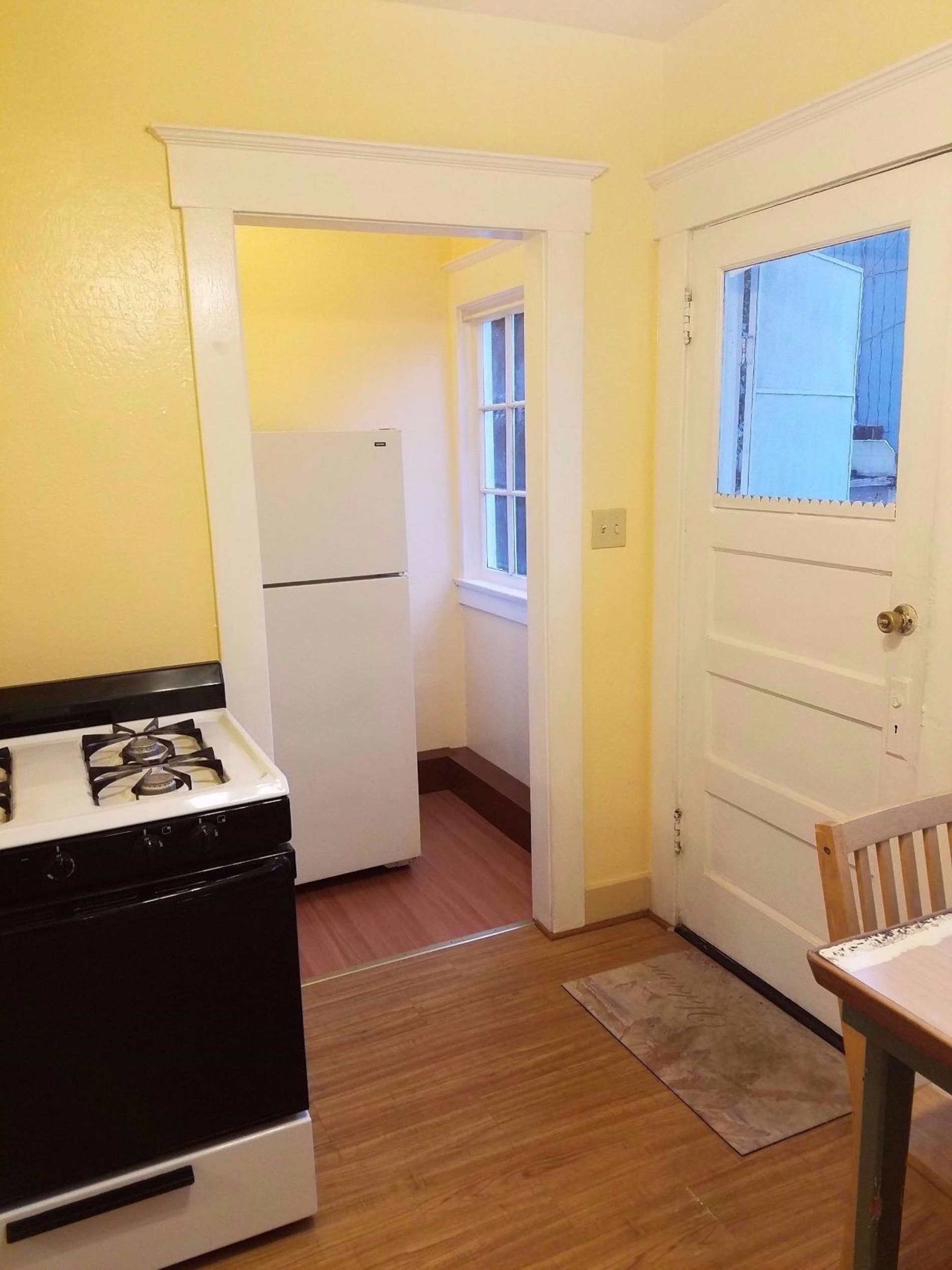 1455 10th Street Reedley, CA 93654 - Photo 3 of 9 a kitchen with a stove and a refrigerator