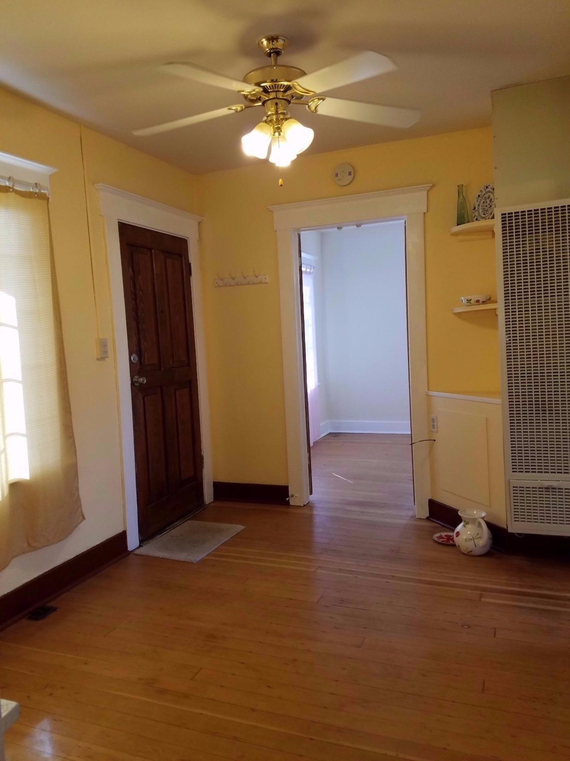 1455 10th Street Reedley, CA 93654 - Photo 4 of 9 wooden floor in an empty room with a window