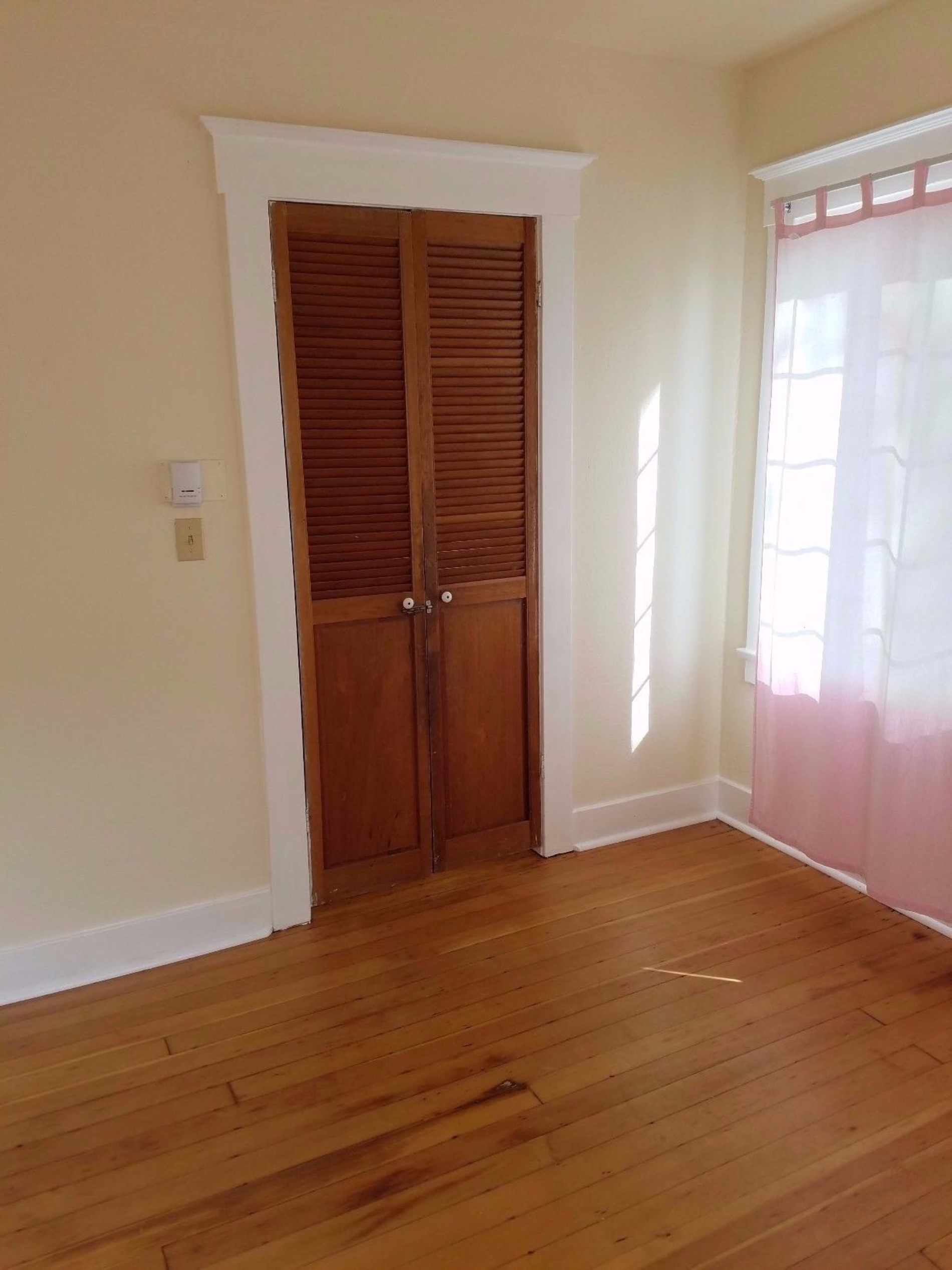 1455 10th Street Reedley, CA 93654 - Photo 6 of 9 an empty room with closet and windows