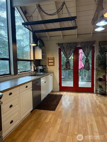 a kitchen with a sink window and cabinets