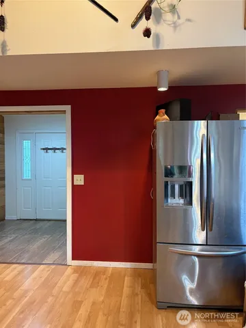 a view of a refrigerator in kitchen and wooden floor