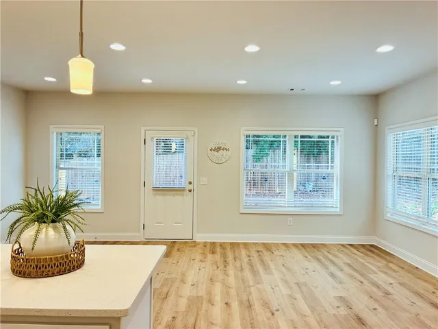 a view of an empty room and window and cabinet