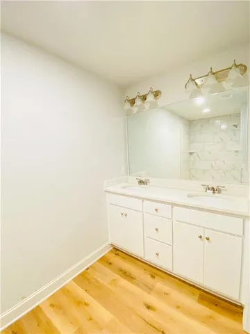 a spacious bathroom with a granite countertop sink and a mirror