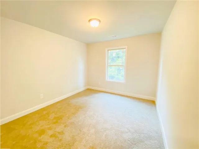 an empty room with a empty space and a window