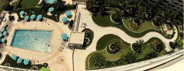 swimming pool view with a garden space