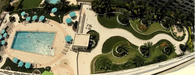swimming pool view with a garden space