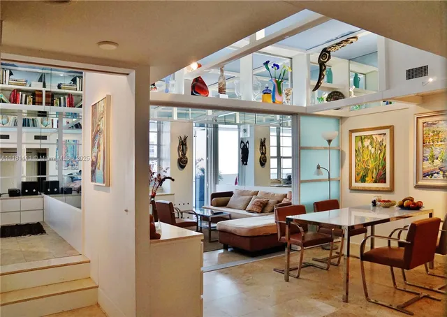 a living room with furniture a rug and a window