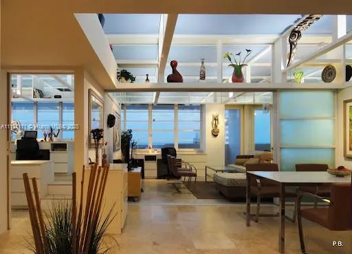 a living room with furniture a dining table and chairs