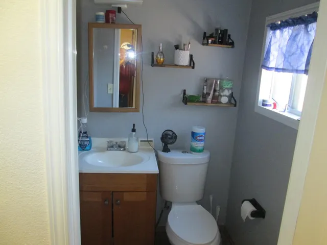 a bathroom with a toilet sink and mirror