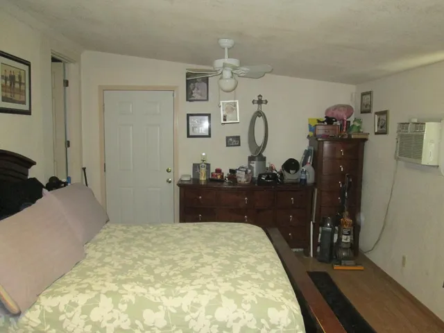 a bedroom with a bed and a dresser
