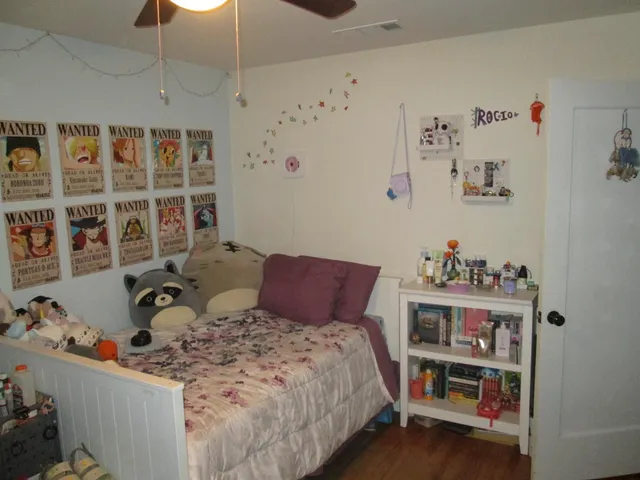 a bedroom with a bed and a window