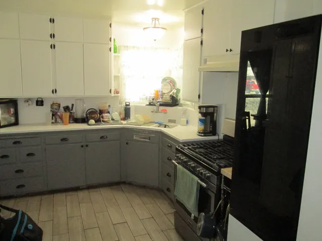a kitchen with a sink appliances and cabinets